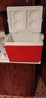 Red plastic cooler open showing interior