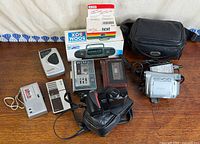 Full group shot of all electronic items, cases and tapes on tabletop