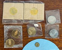 Group shot of all coins and token