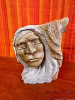 Front view of soapstone bust sculpture showing face detail and overall form