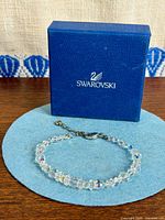 Bracelet displayed on felt pad with Swarovski box