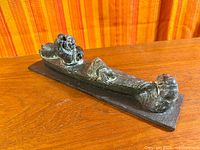 Full view of Inuit-style kayak hunter sculpture on base