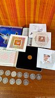 Millennium coin and stamp set with half dollars laid out