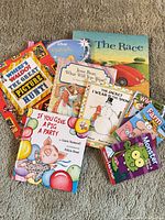 All nine children's books spread on floor, covers visible
