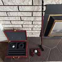 Complete set displayed: putter assembled, case open showing foam slots and components