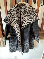 Front view of Simon Chang women’s jacket showing animal-print collar, quilted body, pockets, zipper