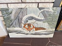 Full view of rigid hardboard painting depicting tiger in snowy setting