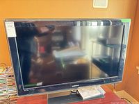 Front view of Samsung flat screen TV on stand