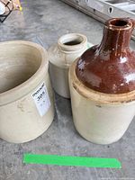 Three stoneware vessels grouped: crock, jug, jar