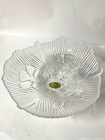 Top view of clear glass bowl showing ribbed sides, floral motif, Murano label