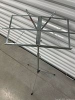 Music stand fully extended showing wire desk and tripod base