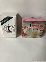 Two original boxes: one for travel mug, one for glass server set