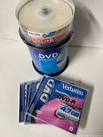 Nexxtech 100-pack spindle, Philips 25-pack spindle stacked on top, four Verbatim single discs displayed