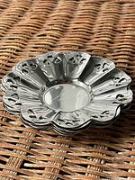 Stacked view of scalloped pierced dishes