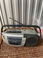 Front view of Sylvania SA85001 boombox showing cassette deck, tuning scale, speaker and handle