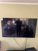 Front view of Samsung 55-inch TV mounted on wall