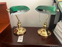 Both bankers lamps front view illuminated