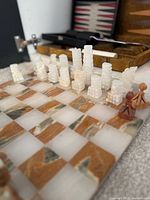 View of onyx chess board and pieces with backgammon case visible in background