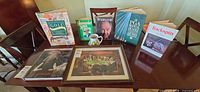 overview of all items on table – framed print, six books, golf mug