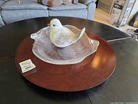 Wood lazy susan with glass platter and bird figurine displayed