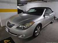 Front left view of silver 2004 Toyota Solara convertible with black soft top