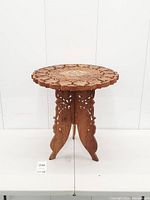 Full view of carved folding side table