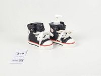 Full view of both ceramic sneaker accessories with lot tag