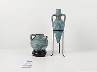 Both vases on their respective stands