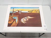 Front view of full unframed Dalí print on table showing image, border, and condition