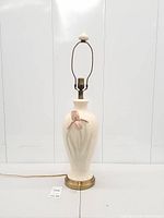 Full view of lamp front showing pink iris flower applique, harp and finial