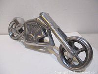 Angled view of cast aluminum motorcycle sculpture