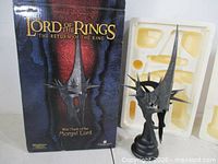 Bust displayed next to original box and foam insert