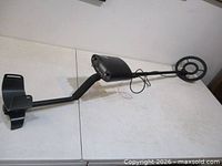 Full view of metal detector showing armrest, shaft, control housing