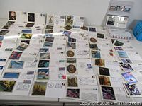 Wide view of spread showing numerous illustrated first day covers