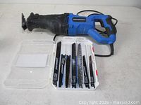 Mastercraft reciprocating saw beside open blade case showing assorted blades