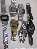 Six digital watches laid out