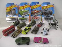 Group shot of all 16 vehicles including 4 sealed Hot Wheels and 12 loose pieces