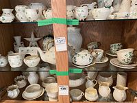 Full view of shelving showing majority of Belleek pieces