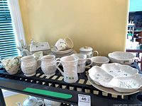 Overall lot showing variety of Belleek Shamrock china on shelf