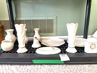 Group shot of all Belleek porcelain items on shelf