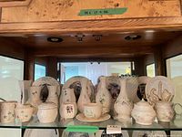 Full shelf view showing entire Belleek grouping