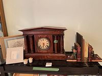 Group view showing mantel clock, bookends, Belleek frame, books and small cups