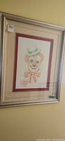 Full view of framed clown drawing showing frame and mat