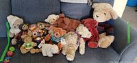 Overview of entire lot on couch showing multiple plush animals and yo-yos