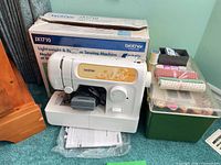 Machine, box, foot pedal, manual, accessory boxes visible