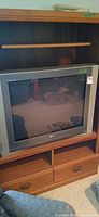 Front view of LG 32-inch gray CRT television in entertainment unit