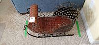 Top and side view of wicker sleigh showing wicker body and metal scroll runners