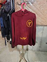 Full view of burgundy hoodie on stand showing overall condition