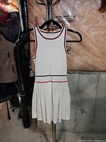 Front view of white sleeveless Celine dress on hanger