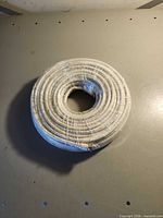 Top view of entire wrapped coil of white coaxial cable